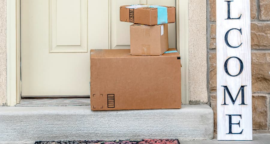 Deliveries on the front porch of a house with a welcome sign in Muncie